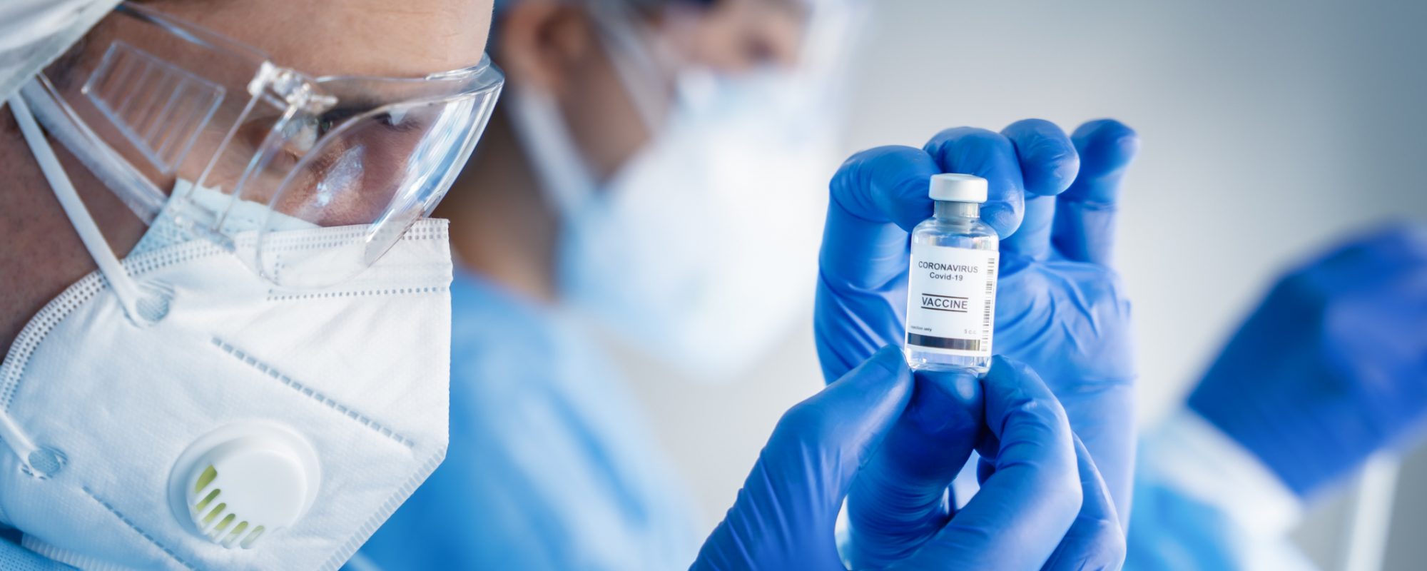 coronavirus covid-19 vaccine bottle in hands of pharmacuetical and vaccine research scientist in laboratory, coronavirus covid-19 vaccine development